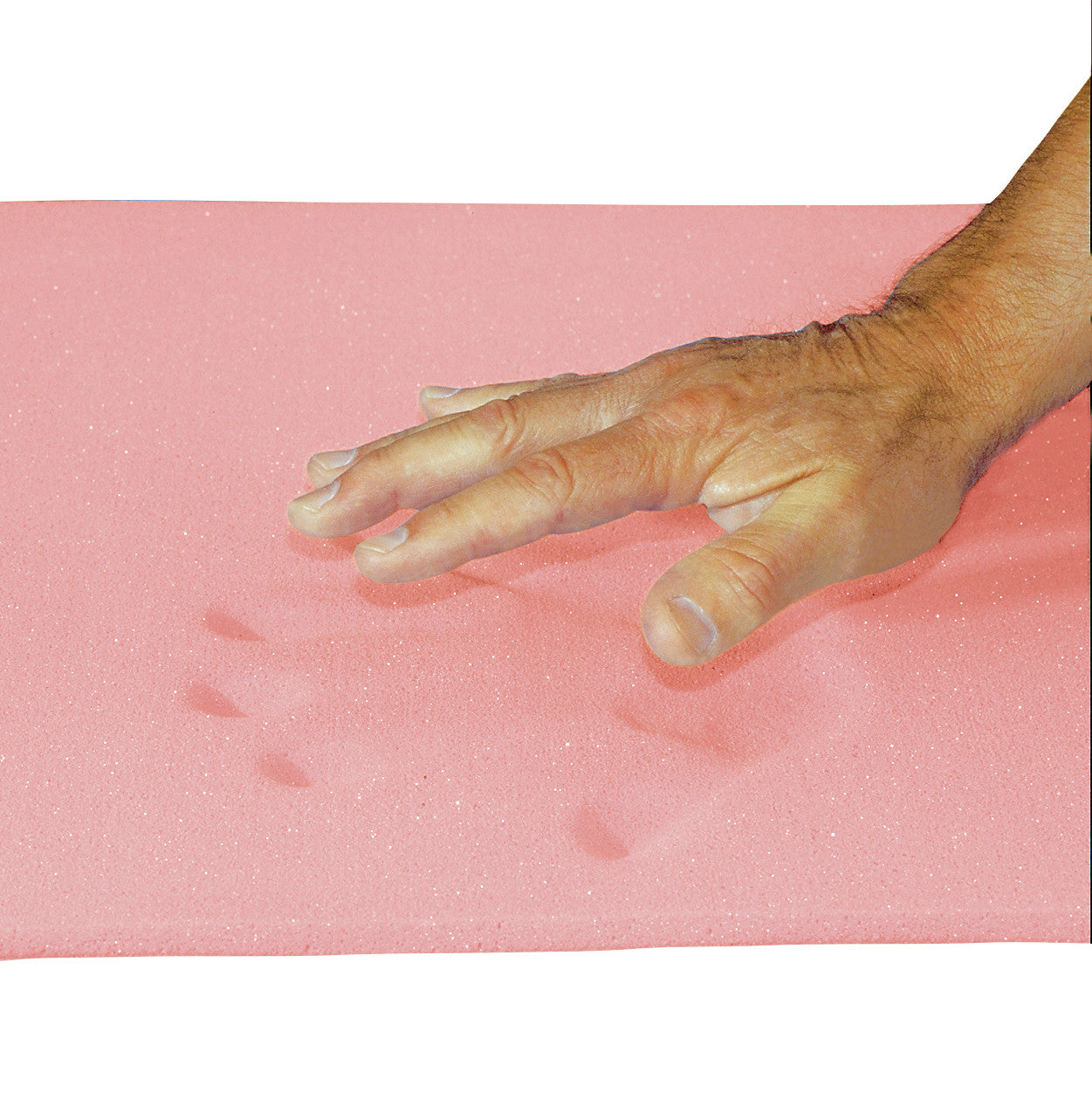 A hand presses down on an AliMed T-Foam Sheet, Bed Size, creating visible indents on the pink foam surface.