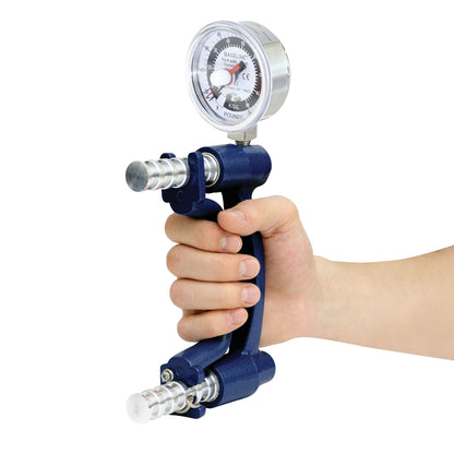 A hand grips the Baseline Analog Dynamometer, displaying a gauge with measurements in pounds and kilograms.
