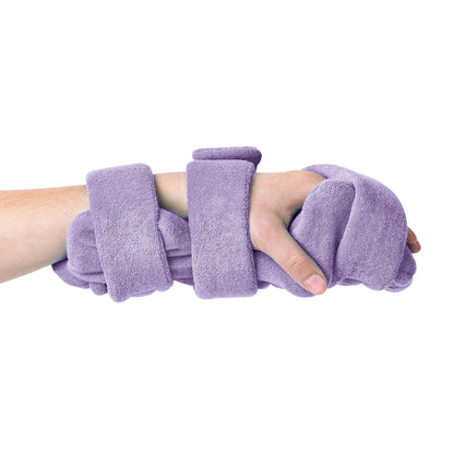 A hand holds a "Comfy Splints Pediatric Hand/Thumb Orthosis" covered in purple terrycloth, designed for support and comfort.