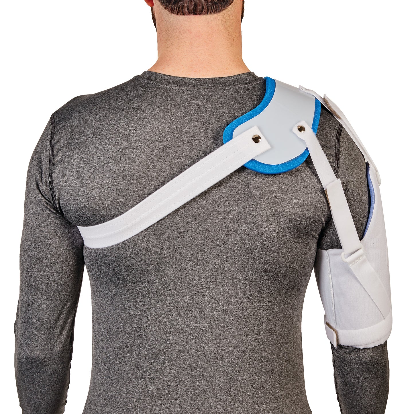 A person wears an AliMed Hemi-Shoulder Sling over a gray shirt, featuring straps and padding around the shoulder and arm.