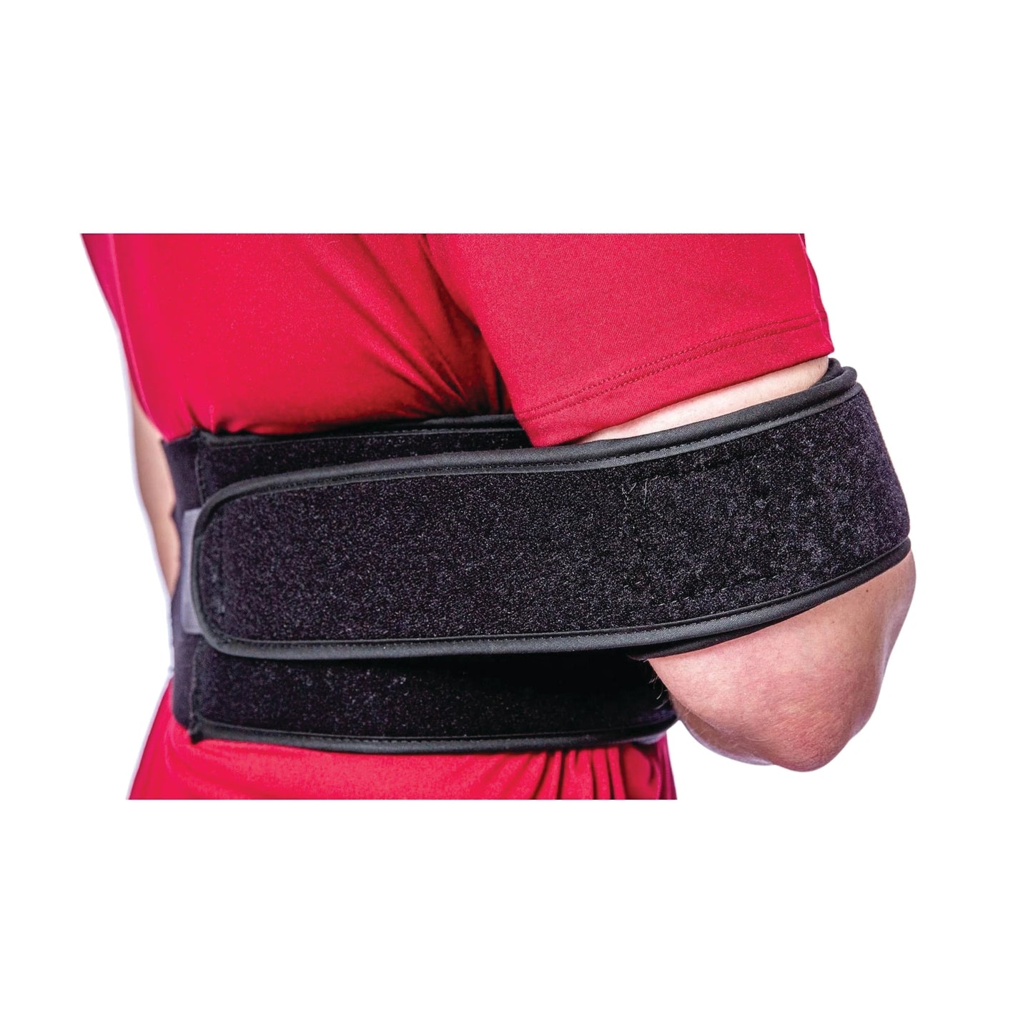 A person wears an Elastic Torso Belt Shoulder Immobilizer. The black belt wraps around their upper body over a red shirt.