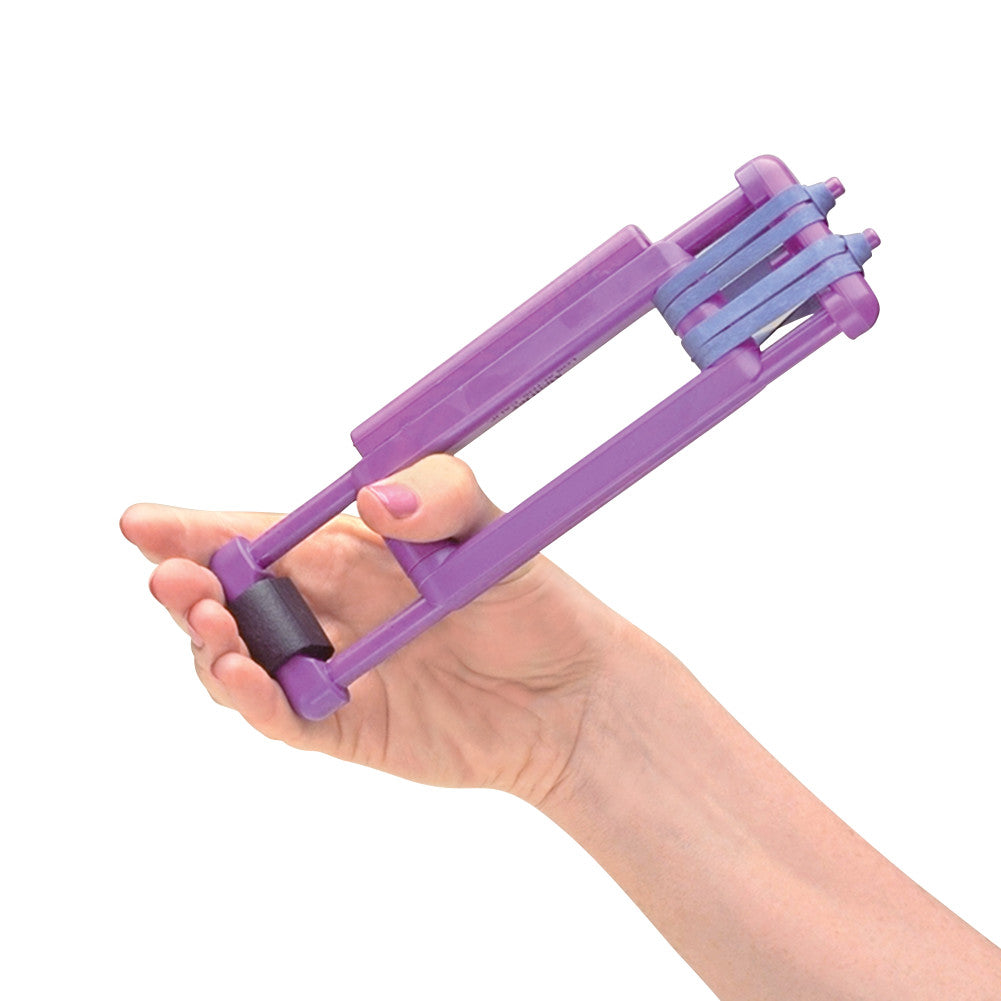 A hand holds a purple Thumb Helper Exerciser with blue bands, designed for finger and thumb strengthening exercises.