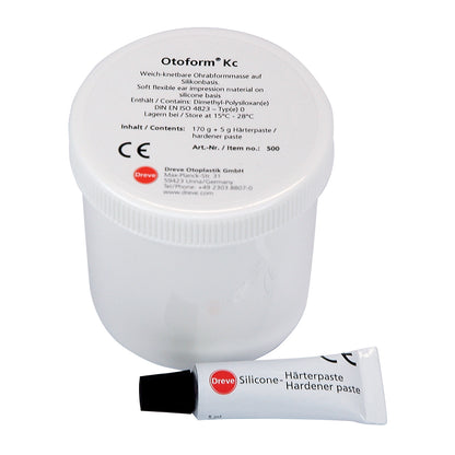 A container of Otoform Kc Elastomer, a silicone-based ear impression material, with a small tube of hardener paste beside it.