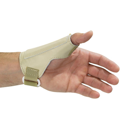 A hand wearing the AliMed Low-Profile Thumb Stabilizer, which is a beige support brace for thumb immobilization and protection.