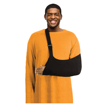 A person wearing a Brownmed Joslin Ultimate Arm Sling over an orange sweater, smiling. The sling supports their arm.
