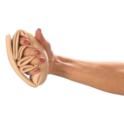 A hand holds the DermaSaver Finger Separator, a beige, padded cloth device designed to separate and protect fingers.