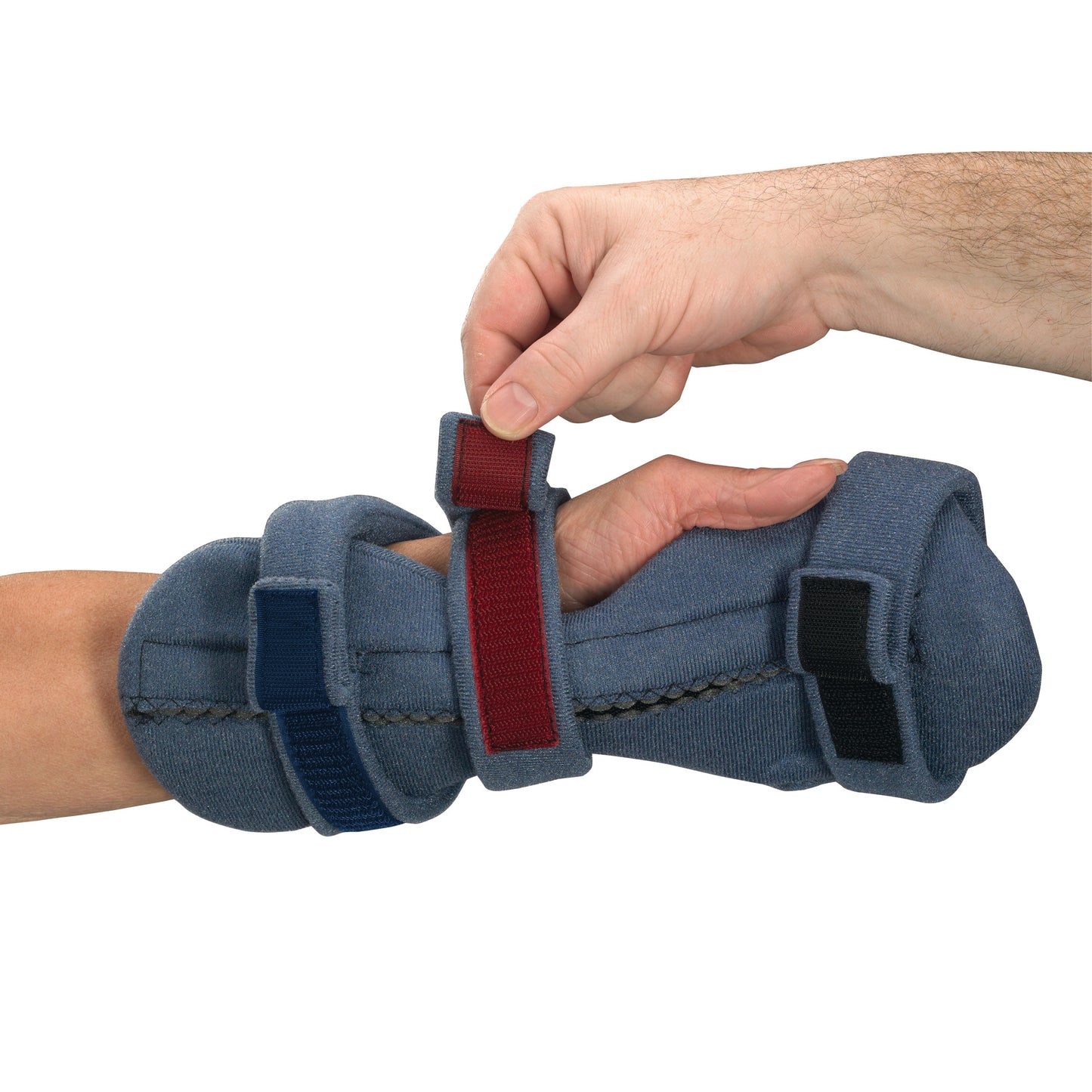 A person adjusts the red strap on an OCSI SoftPro Palmar Resting WHFO orthotic, which is wrapped around a forearm and hand.