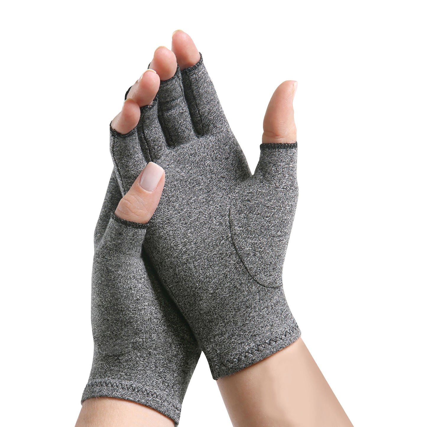 Hands wearing Brownmed IMAK Compression Arthritis Gloves, designed in a gray fabric with open fingertips.