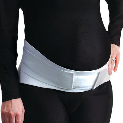 A pregnant person wears the Embrace Moderate Support Maternity Belt over a black outfit, providing support to the lower abdomen.