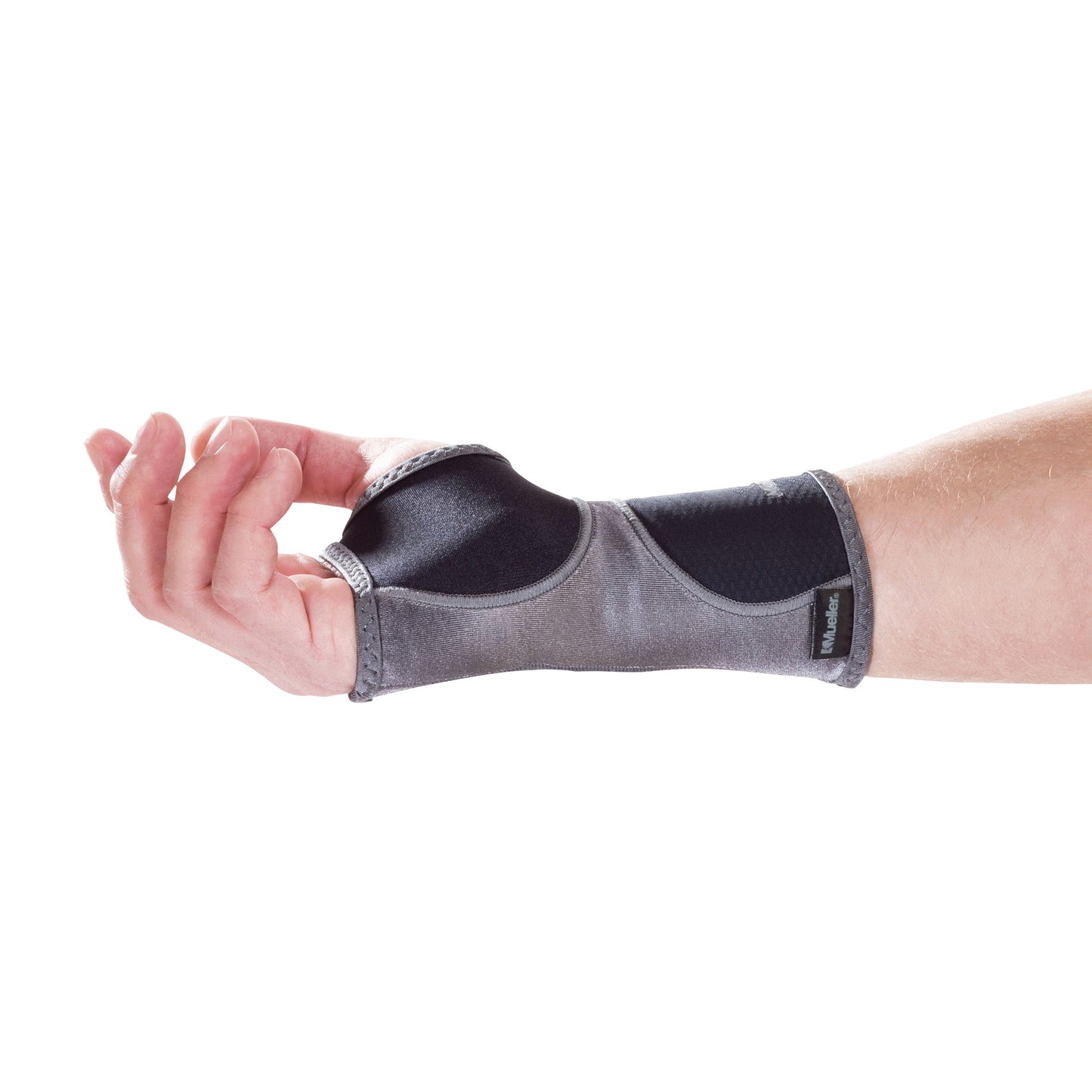 A hand wearing a Mueller Hg80 Wrist Support, gray with black accents, providing compression and support for the wrist.