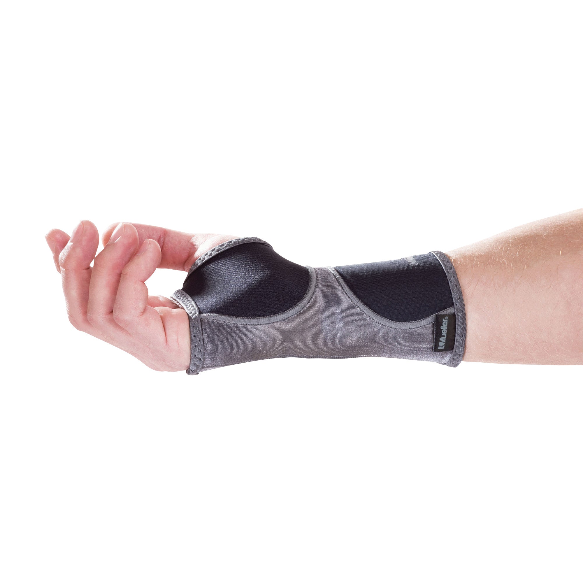 A hand wears a Mueller Hg80 Wrist Support, a gray and black brace providing support around the wrist and thumb area.
