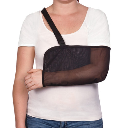 A person wears the AliMed Mesh Arm Sling in black, supporting their right arm. They are dressed in a white shirt and jeans.