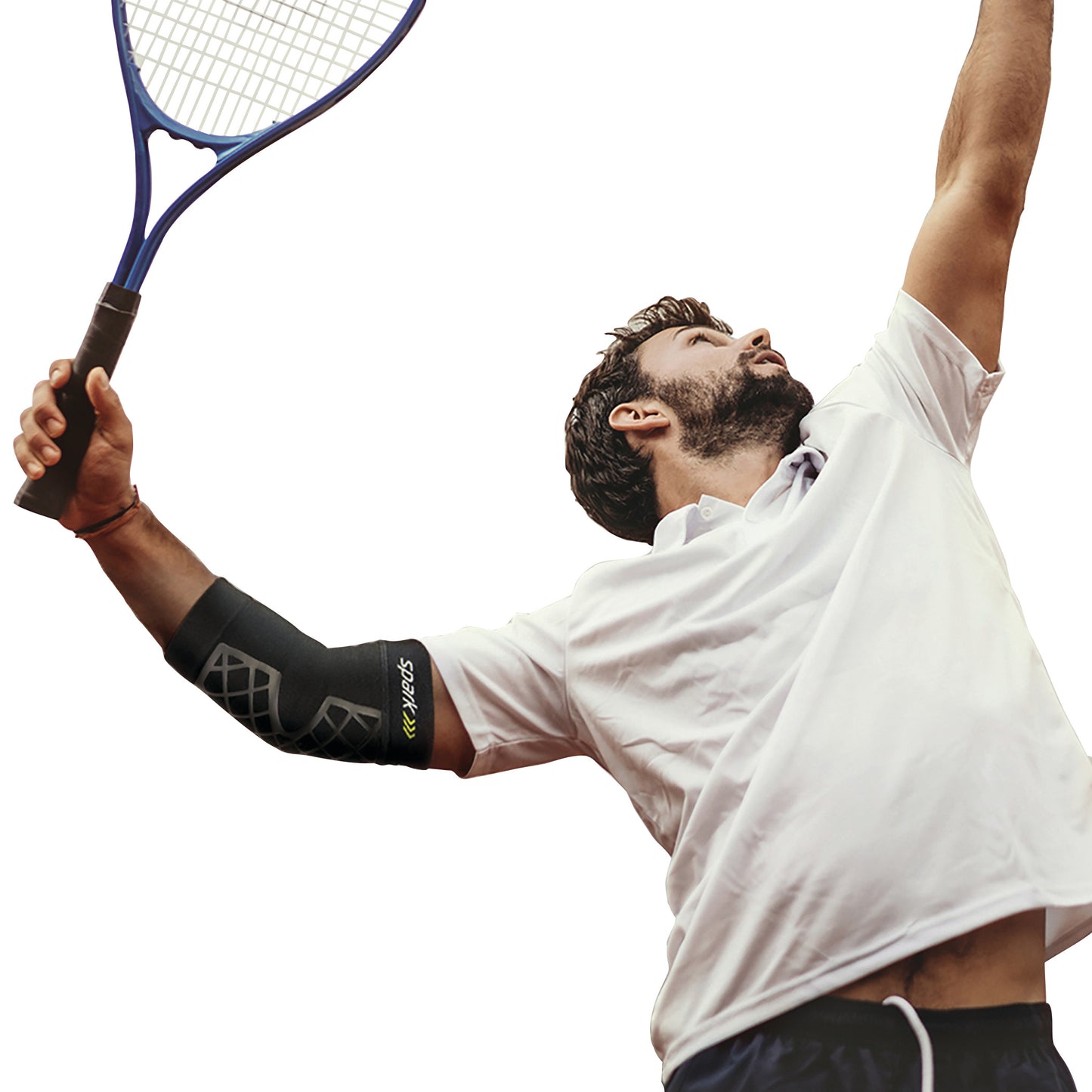 A person wearing a BrownMed Spark Kinetic Elbow Sleeve while holding a tennis racket. The sleeve is black with a geometric design.