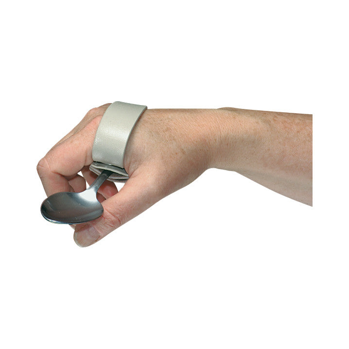 A hand wearing a Palmar Clip ADL Cuff holds a spoon. The cuff aids in gripping utensils, featuring a secure strap around the palm.