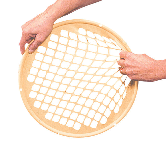 Two hands stretch a beige Power-Web Exerciser, a circular, flexible resistance tool with a web-like pattern for hand therapy.