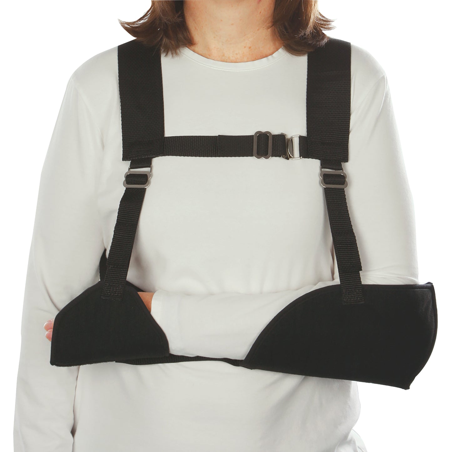 Woman wearing a Harris Hemi-Arm Sling, supporting the arm with black straps and a chest buckle, over a white shirt.