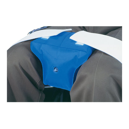 A person wears the AliMed Inflatable Knee Abduction Pillow between their knees, secured with white straps over dark pants.