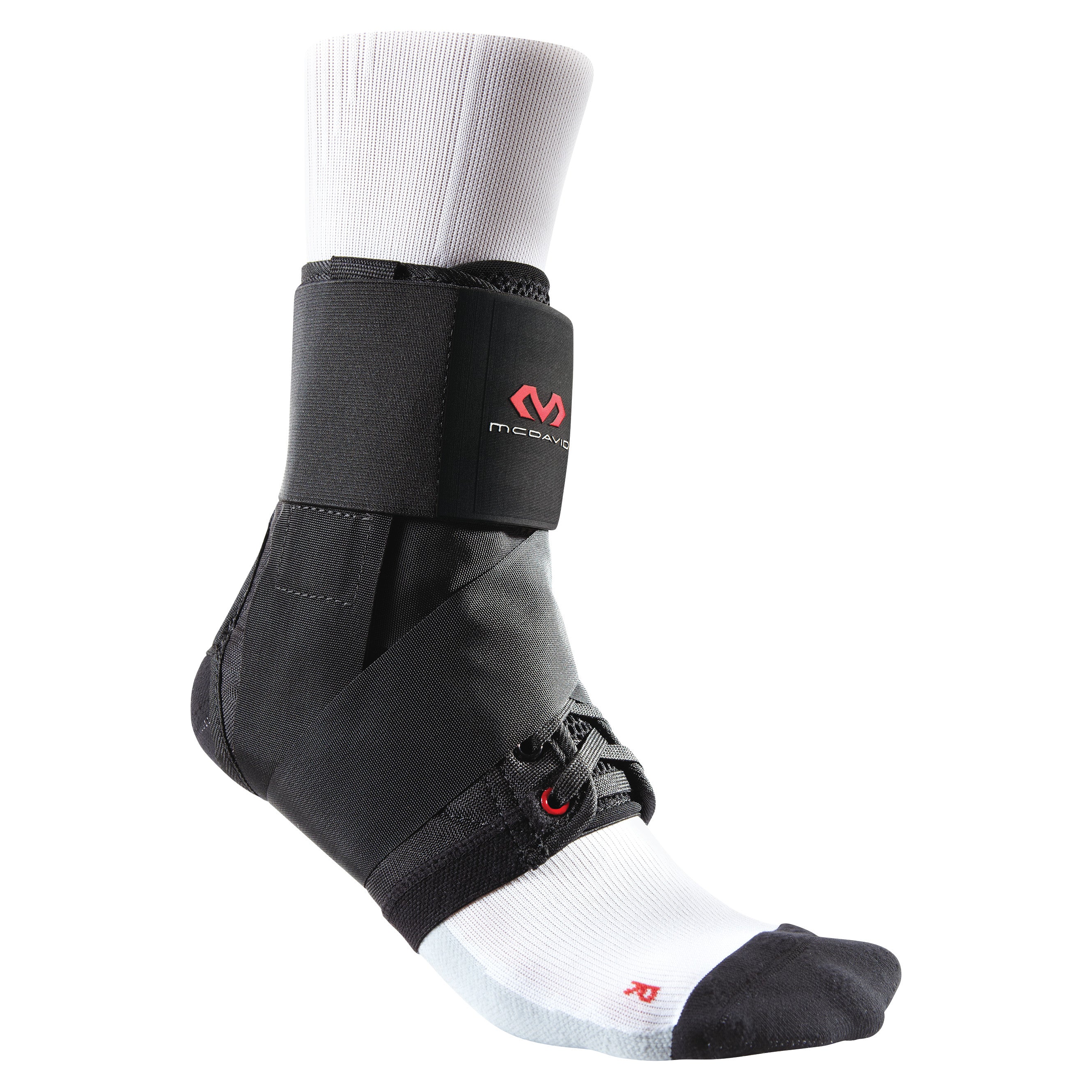 The McDavid Ultralight Ankle Brace is shown on a foot wearing a white sock. It has black straps and provides support.