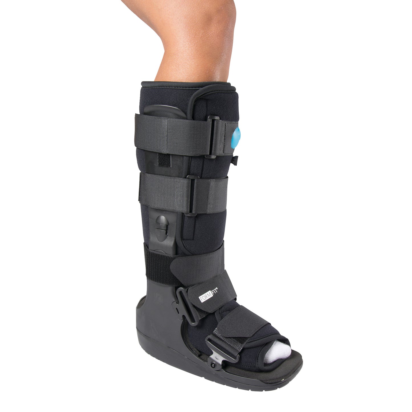 A person's lower leg is in an Ossur Formfit High-Top Air Walker. It has black straps and a rigid sole for support and protection.