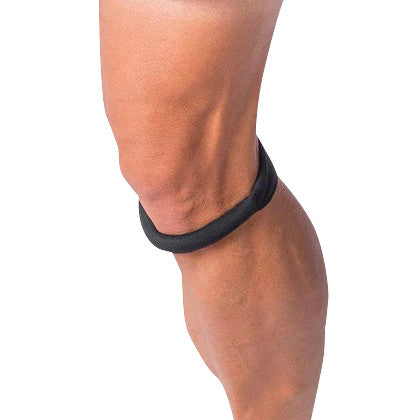 A Cho-Pat Knee Strap is wrapped around a person's knee, providing support just below the kneecap.