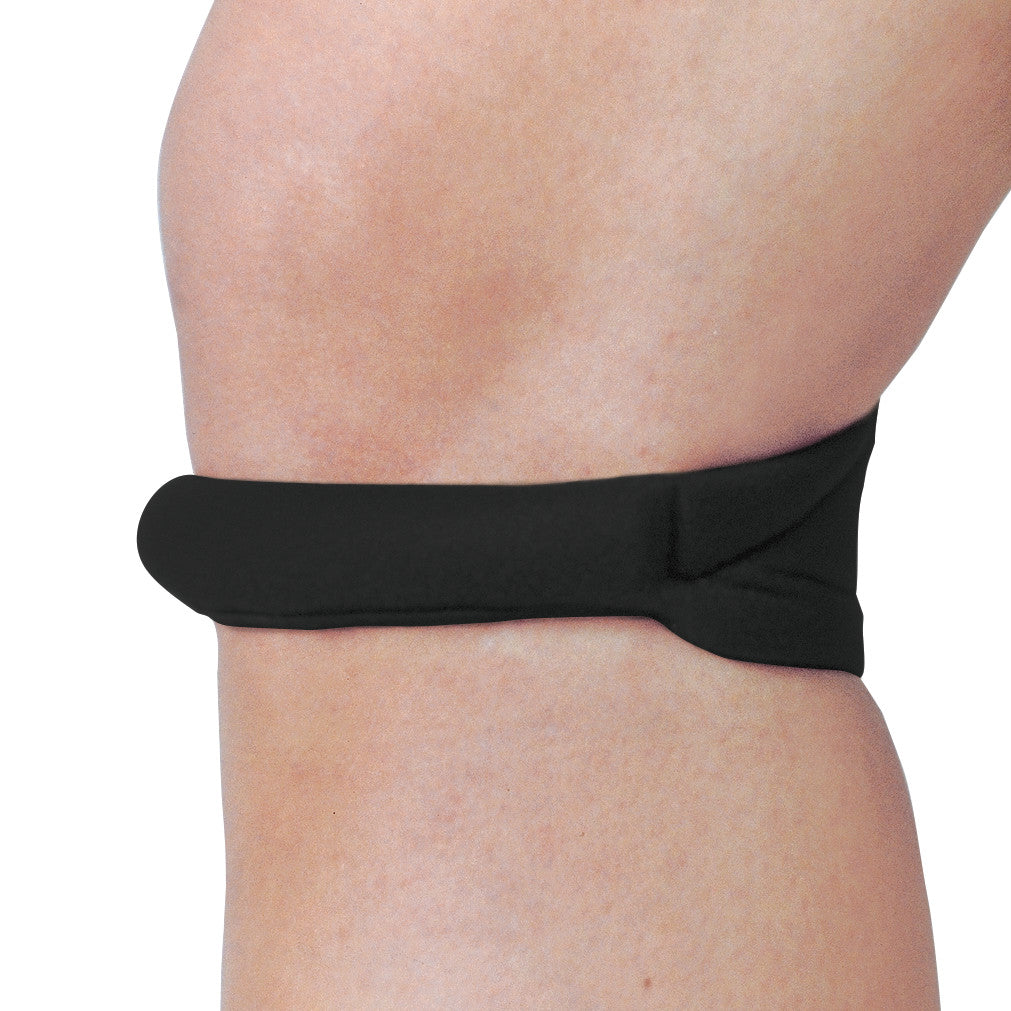 Side view of a leg wearing a black Cho-Pat Knee Strap, wrapped just below the knee for support.