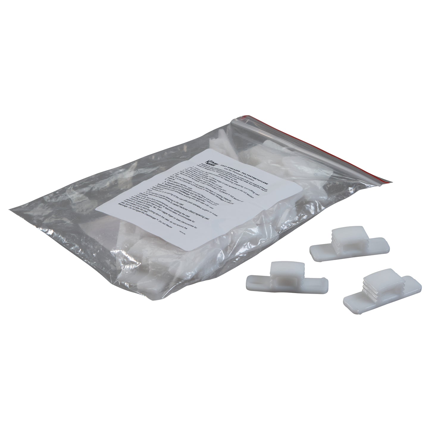 A plastic bag with "Replacement Wedge for CastWedge Starter Set" and three white wedges on a white surface.