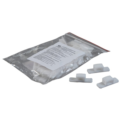 A plastic bag with "Replacement Wedge for CastWedge Starter Set" and three white wedges on a white surface.