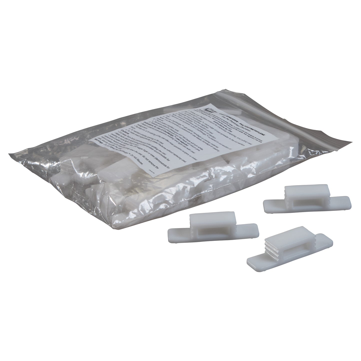 Plastic bag with "Replacement Wedge for CastWedge Starter Set" and three white plastic wedges placed outside the bag.