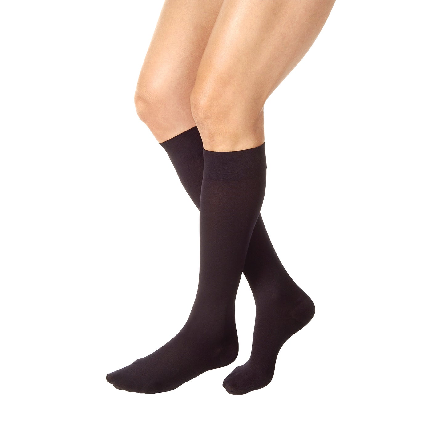A person wearing Jobst Relief Thigh-High Compression Stockings in black, covering the legs from foot to just above the knee.