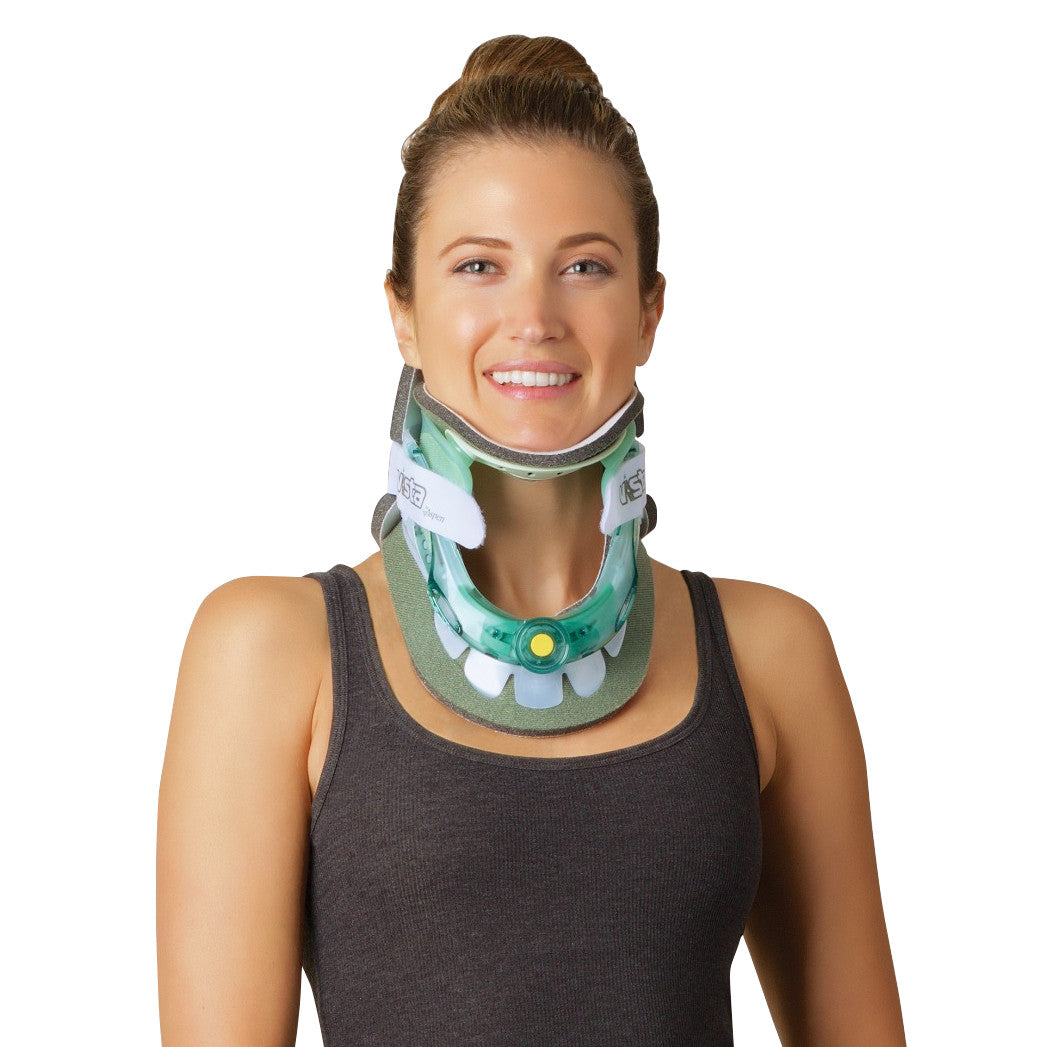 A woman wears an Aspen Vista Cervical Collar Set, a supportive neck brace. She's smiling and dressed in a dark tank top.