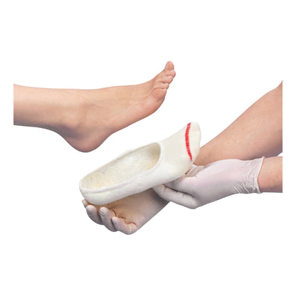 A hand in gloves holds a white slipper from the STS Slipper Sock Variety Pack, with a bare foot nearby, on a white background.