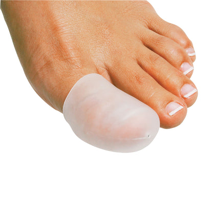 A close-up of a foot wearing a PediFix Visco-GEL All-Gel Toe Cap on the big toe, showing clear gel material for cushioning.