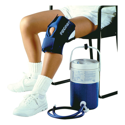 A person sits with an Aircast Cryo/Cuff IC System on their knee. The system includes a blue knee wrap and a connected cooler.