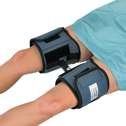 A person wearing the OCSI SoftPro HKO (Hip/Knee Orthosis) on both legs. The orthosis is blue with black straps and connectors.