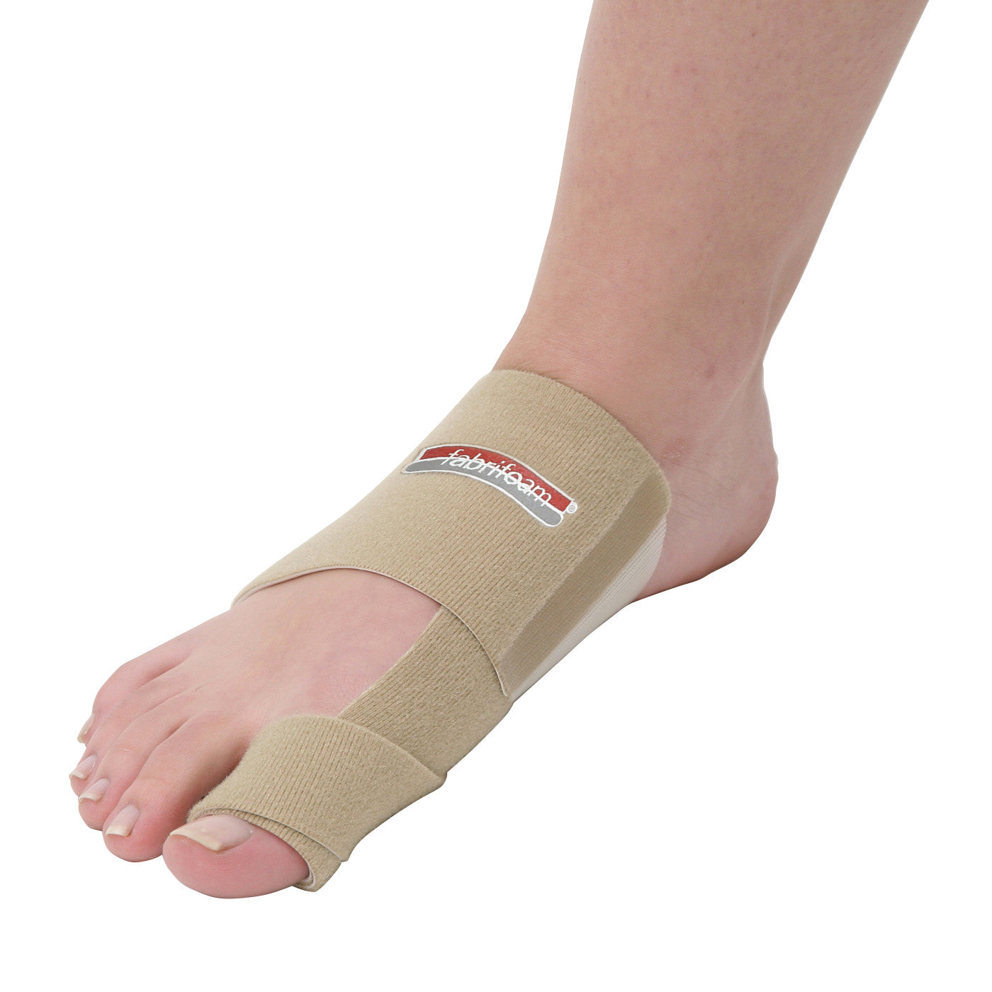 A foot is wearing a beige Bunion Sling, featuring a strap around the big toe and across the midfoot with a branded label on top.