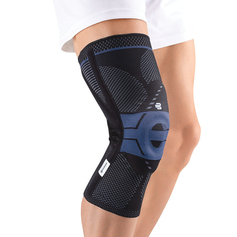 A person wearing a Bauerfeind GenuTrain P3 knee brace, featuring a black and blue design, providing knee support and compression.