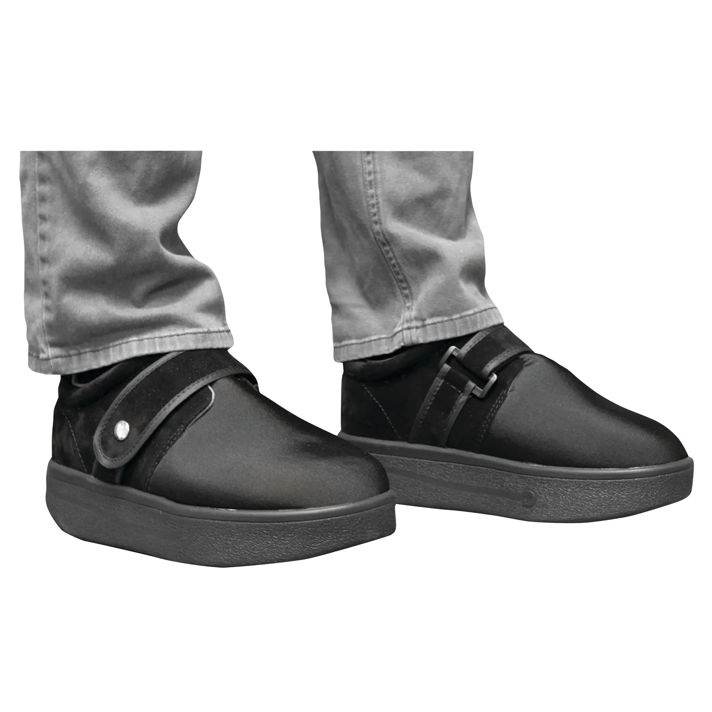 Person wearing DARCO Closed Toe Wound Care Shoe System, with black shoes and gray pants, featuring a strap closure.