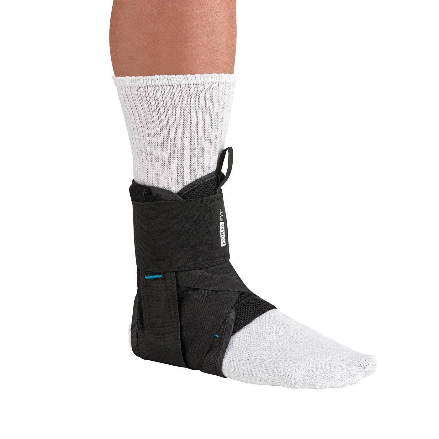 A person wearing the Ossur Formfit Ankle Brace with Speedlace over a white sock. The brace is black and provides ankle support.