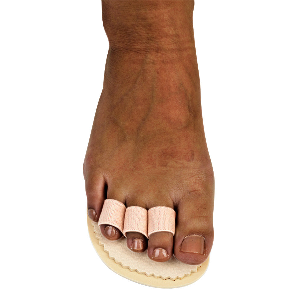 Foot wearing a Silipos Toe Splint on three toes, supported by a cushioned base, providing alignment and separation.
