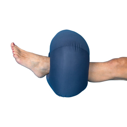 A foot rests on the DermaSaver Blue Donut Heel Elevator, which cushions and elevates the heel for comfort and support.