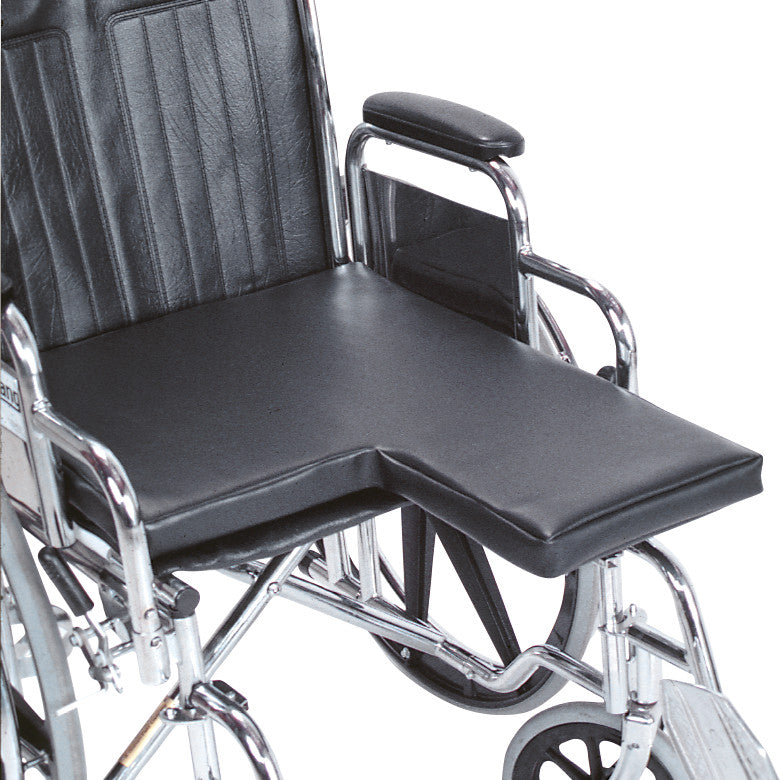 AliMed Amputee Wheelchair Surface in black is shown on a wheelchair. It features a cut-out section for accommodating amputees.