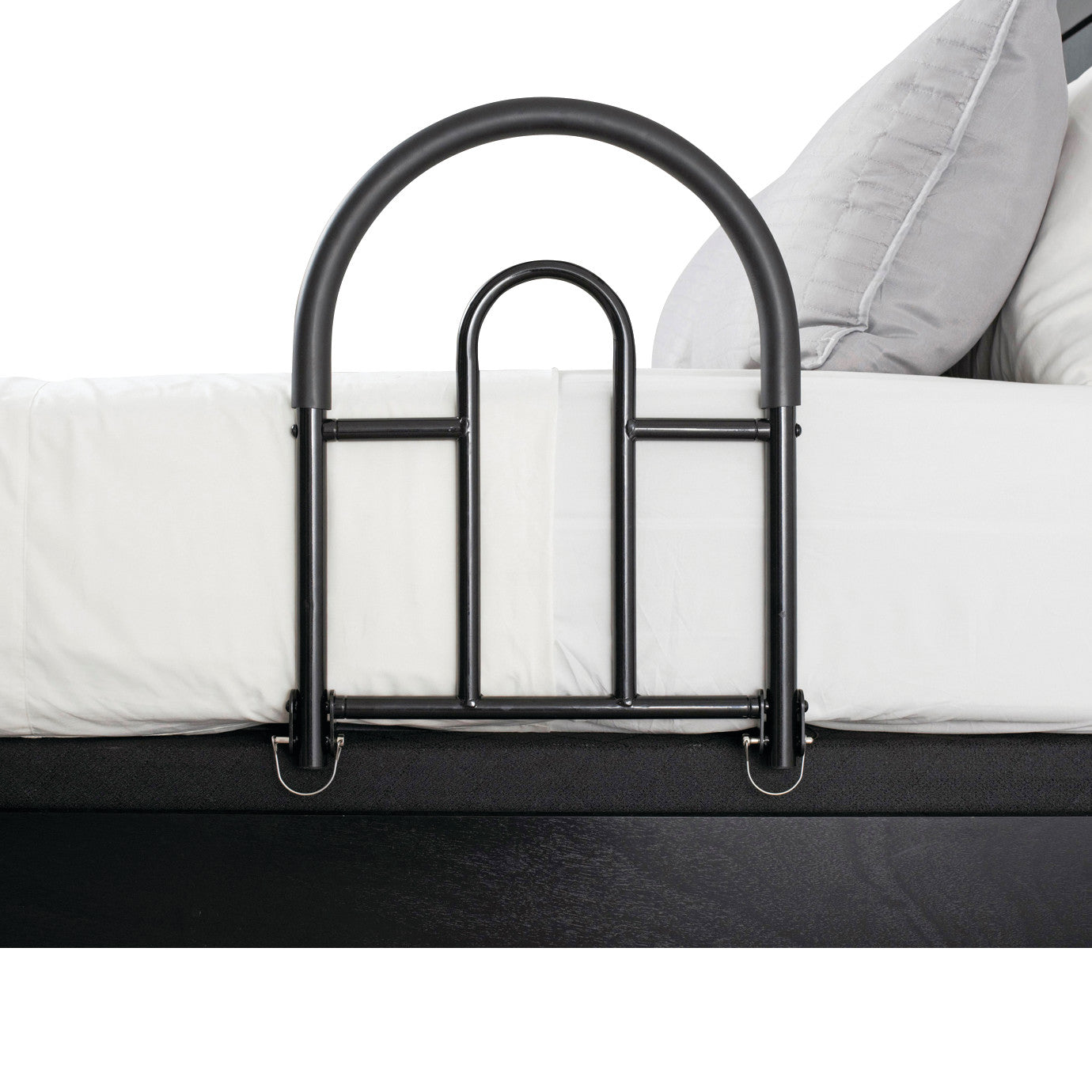 A black 'Bed Rail Advantage Traveler' is attached to a bed with white sheets and a gray pillow, offering safety and support.