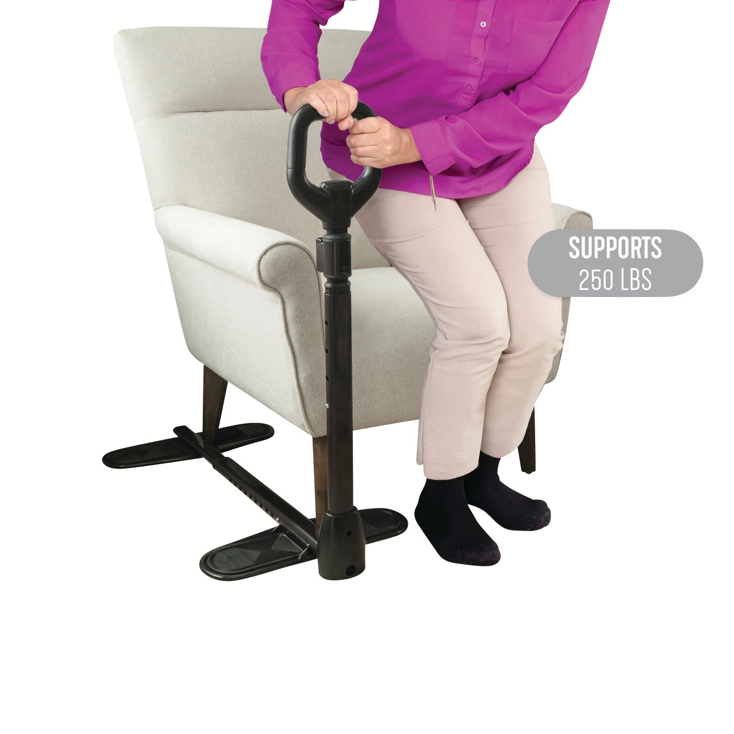 A person uses the Stander CouchCane, a standing aid attached to a chair, supporting up to 250 lbs for assistance in standing up.