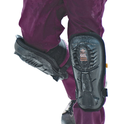 A person wearing Impacto Gel Knee/Shin Pads over purple pants, shown from the side with black boots on a white background.