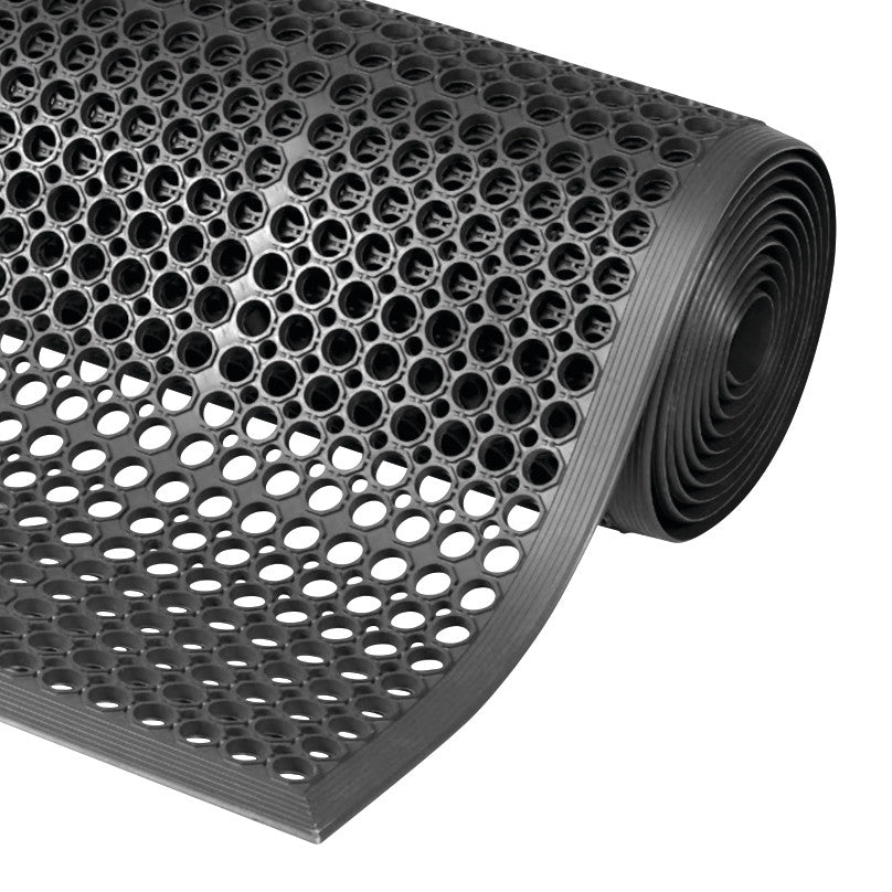 A rolled Sanitop Drainage Anti-Fatigue Mat with round perforations for drainage. The mat is black and textured.