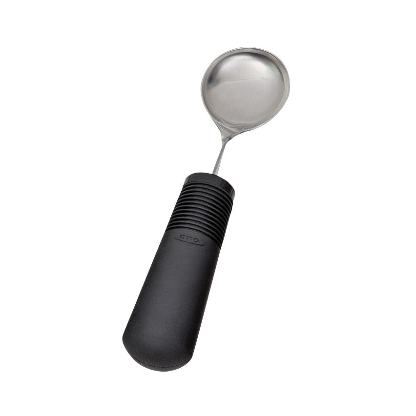 A Good Grips Weighted Utensils ladle with a black ergonomic handle and a stainless steel bowl, designed for comfortable gripping.