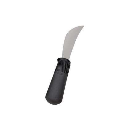 A curved steel knife with a thick black handle, labeled "Good Grips Weighted Utensils," designed for ease of use.