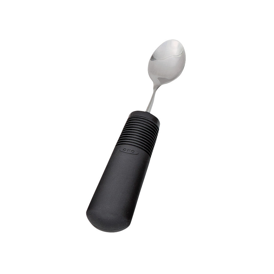 A Good Grips Standard Utensils spoon with a stainless steel head and a black, non-slip, comfortable handle.