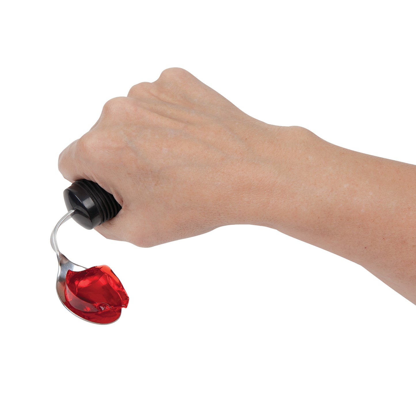 A hand holds a Good Grips Standard Utensil spoon with a red jelly-like substance. The handle is thick with a black grip.