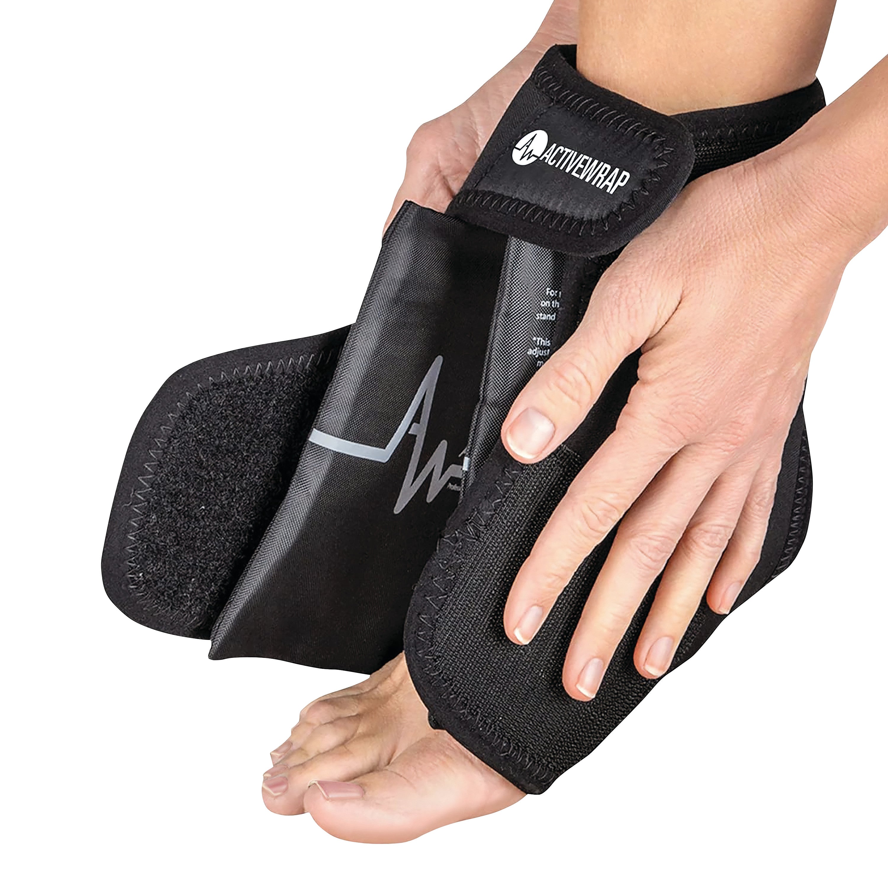 A person adjusts an ActiveWrap foot and ankle therapy wrap on their foot. The wrap is black with a visible brand logo.